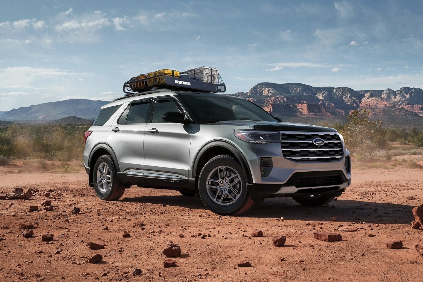 2025 Ford Explorer parked in a red rocky terrain with red rock mountains behind it