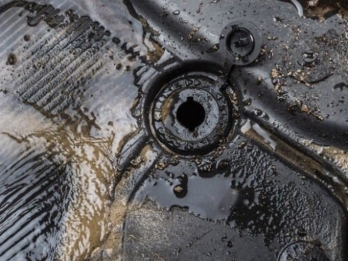 2024 Ford Bronco close up view of water draining in drainage plug in rubber mats