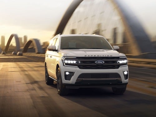2024 Ford Expedition driving on a bridge outside a city