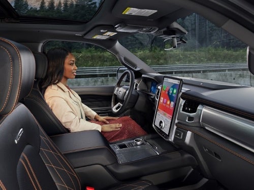 2024 Ford Expedition view of woman in the driver seat taking advantage of the hands free driving feature