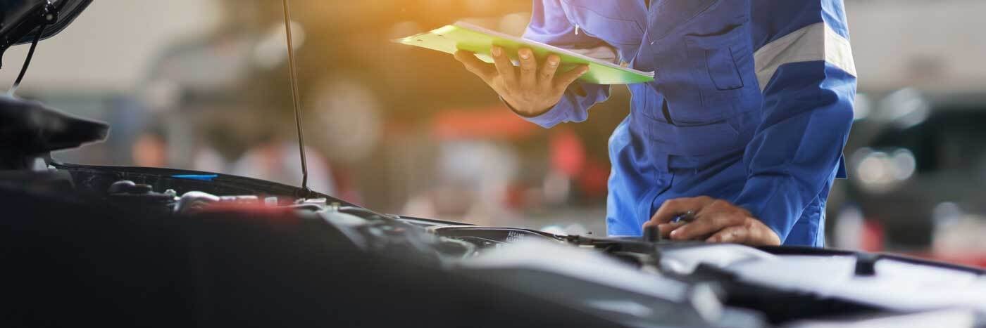 Close up view of a service tech inspecting an engine
