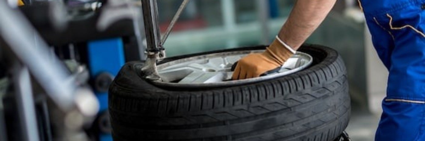 close up view of a service tech repairing a tire